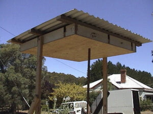 Resonator box under shelter. Central bridge carries vibrations from the wires to the soundboard.
